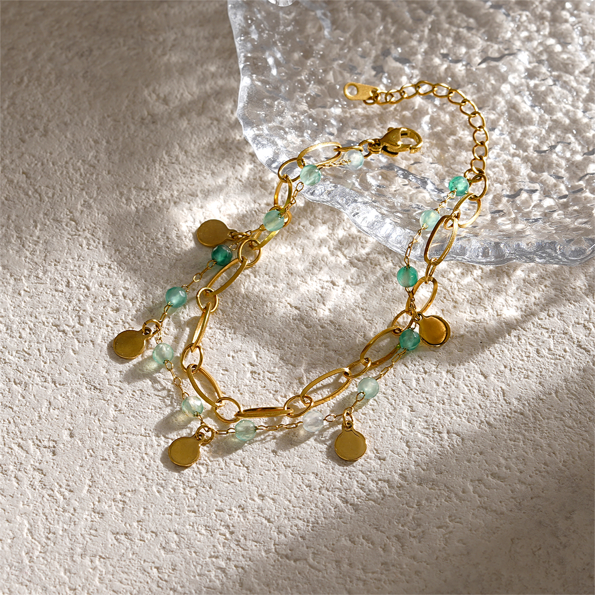 Double Layer Gold Bracelets Featuring Faceted Stones And Unique Charms
