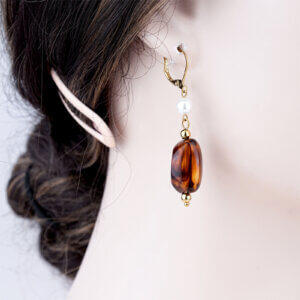 Gold plated dangle earrings with shell pearl and acrylic centerpiece